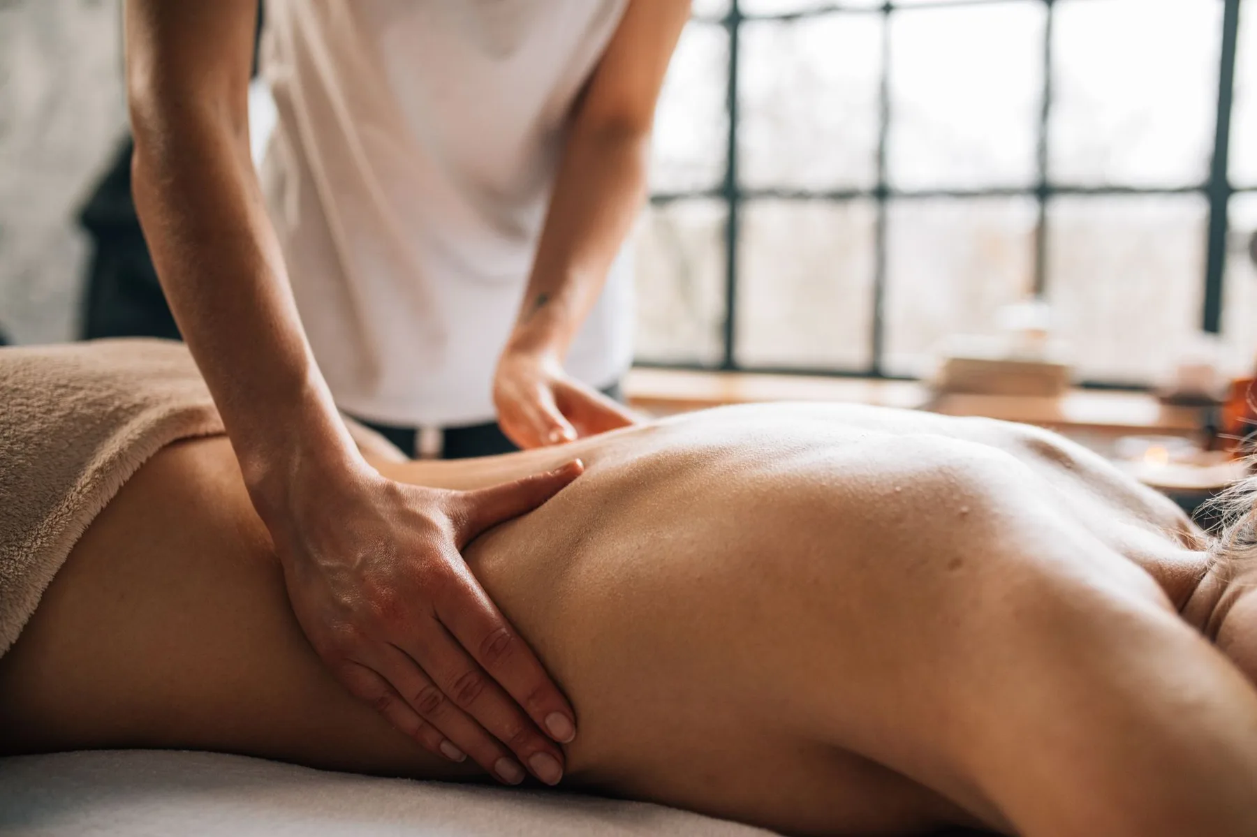 Deep tissue massage on the lower back