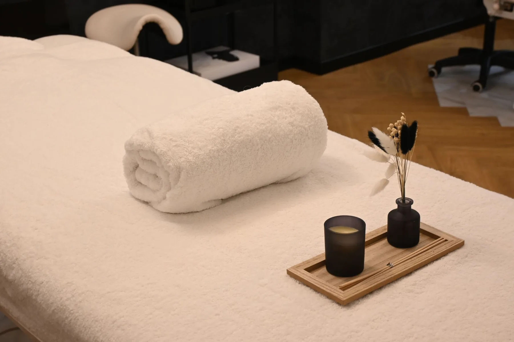 Quiet treatment room with a rolled towel and candle